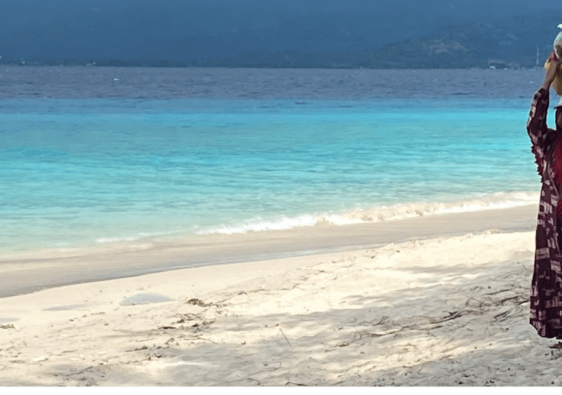 woman walking across the beach on Gili Meno