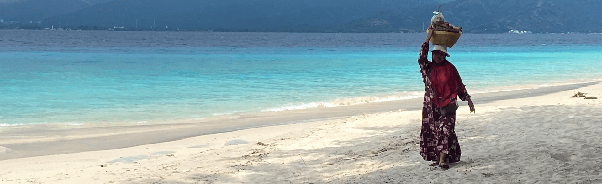 woman walking across the beach on Gili Meno