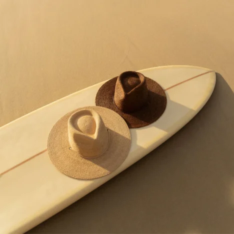 will and bear hat on a surfboard